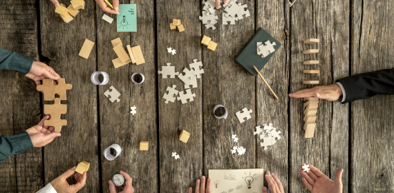 People playing with jigsaw puzzles and dominoes